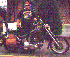 A picture of me standing next to my Harley Davidson motorcycle.